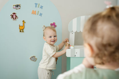 A toddler playing happily with Tix&Mix magnetic toys.