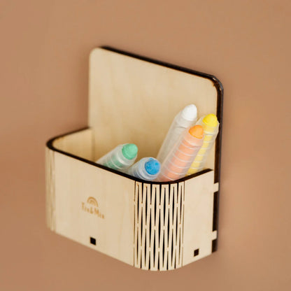 Five colorful crayons stored in a Tix&Mix magnetic wooden magic box.