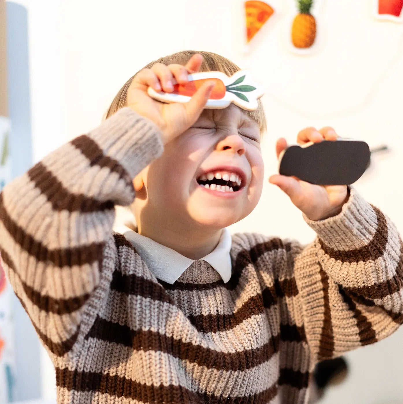 A child playing happily with Tix&Mix wooden magnetic food playset.